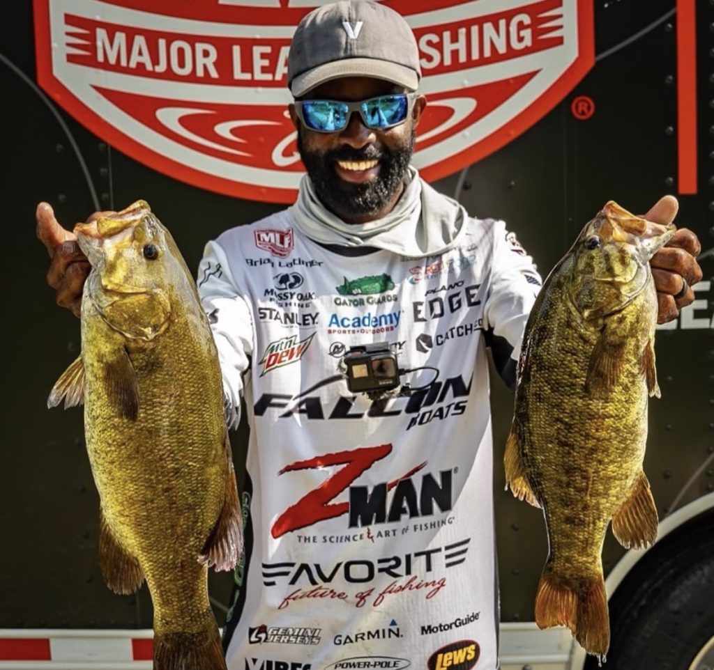 pro fisherman holding 2 big bass